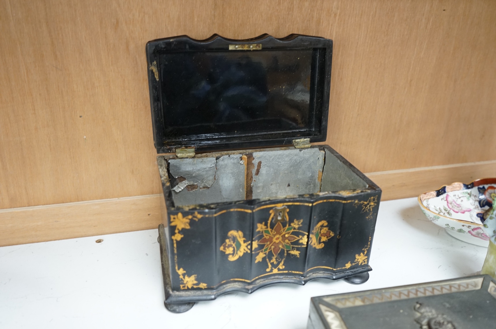 A Victorian papier maché tea caddy, postal scales and a military interest cigarette box, largest 19cm wide